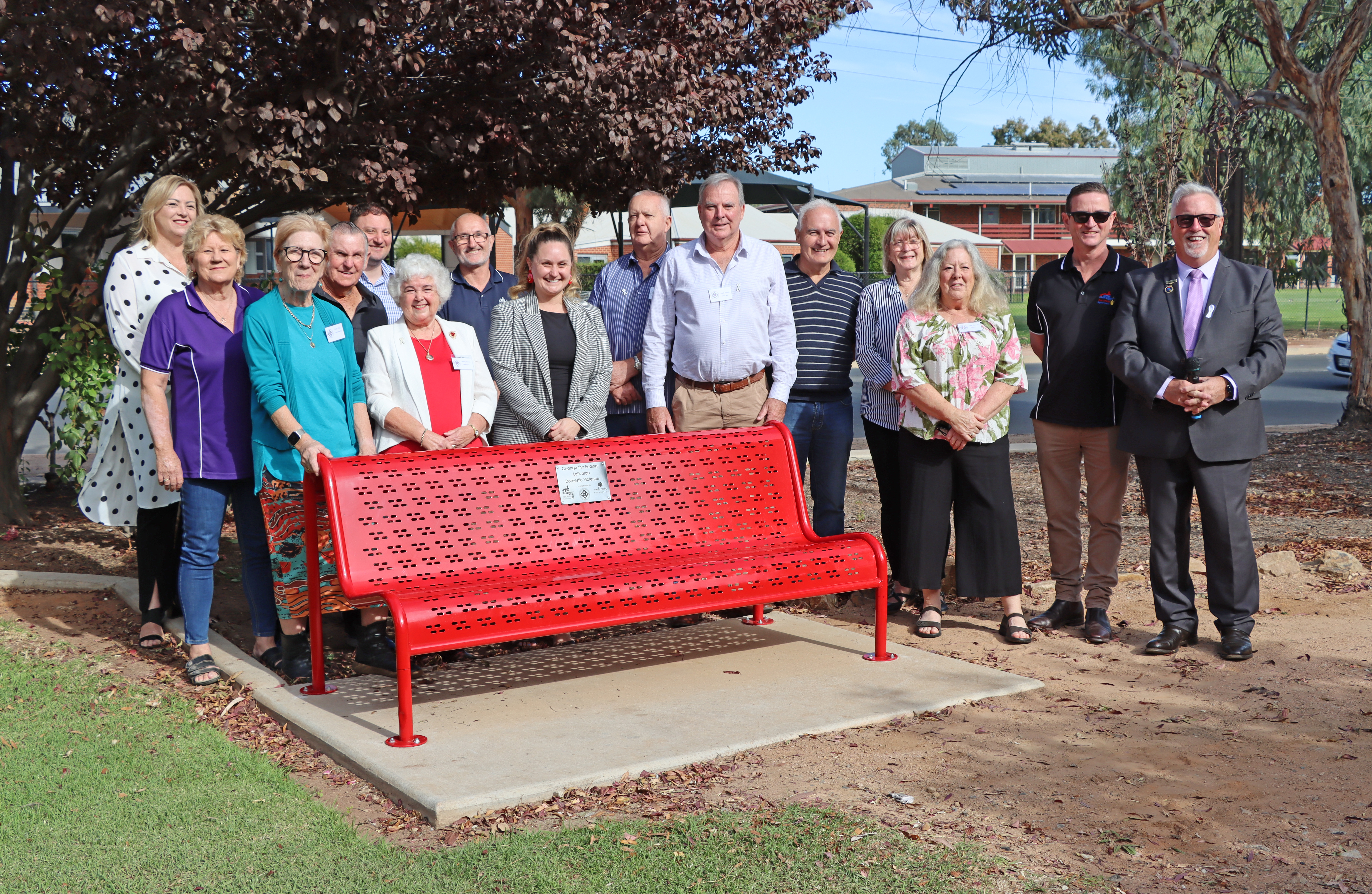group photo at unveiling of red bench