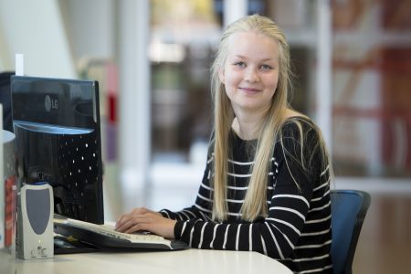 Photo of person sitting at library computer
