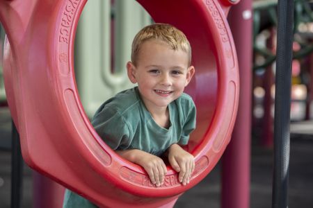 Boy playing on local playground